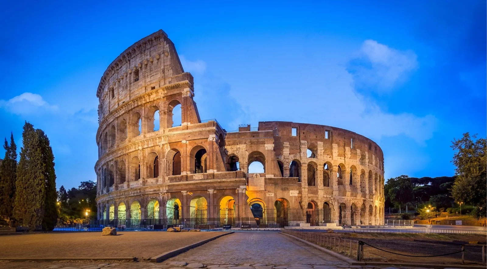 The Colosseum lit at blue hour after closing time