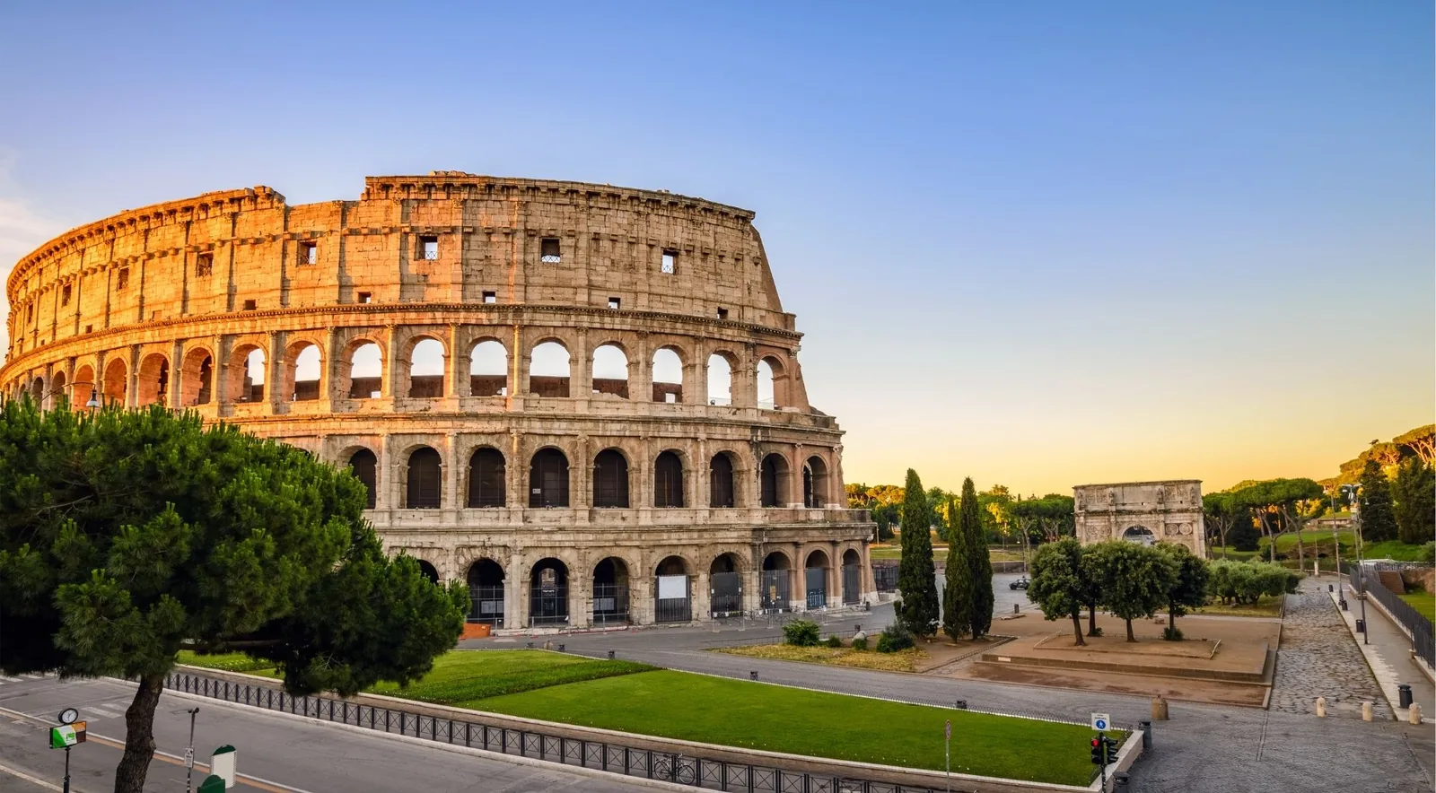 The Colosseum and Arch of Constantine at sunrise with almost no crowds — the reward for skipping the line early